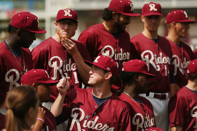 Frisco RoughRiders teammates stand in place before a team photograph during Frisco...