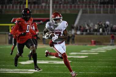 Oklahoma wide receiver Marvin Mims Jr. (17) runs for a touchdown while Texas Tech defensive...