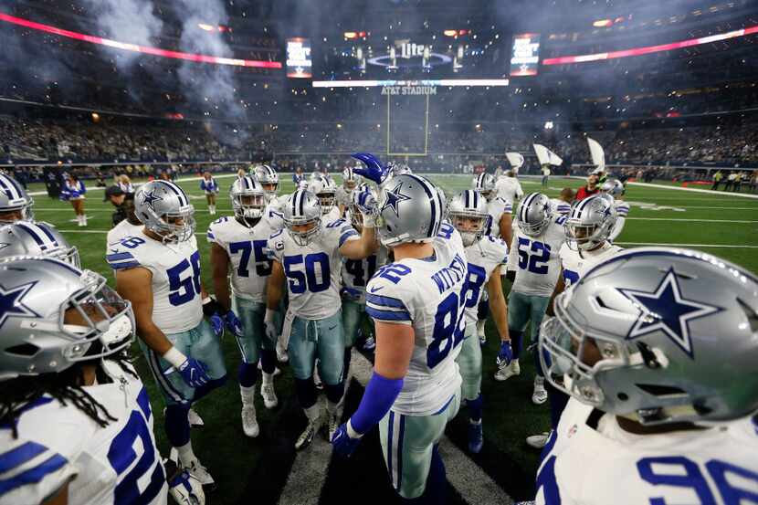 Dallas Cowboys' Jason Witten (82) and Sean Lee (50) lead the huddle on the field before an...