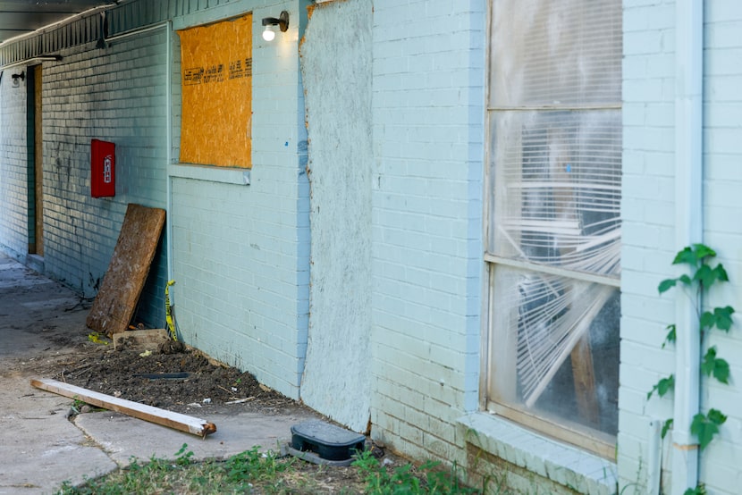 Vacant units boarded up with plywood and plastic material windows at Frances Place...