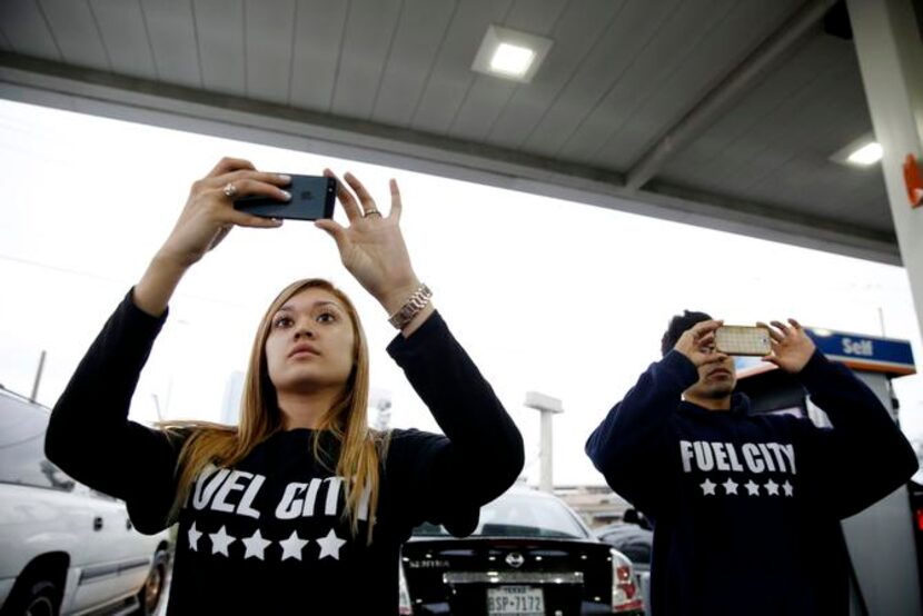 
Fuel City cashier Cynthia Arguello (left) and stocker Juan Ramos take photos for the gas...