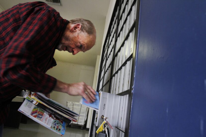 Dean Suiter of Seagoville checks the mail in his P.O. box in the Seagoville branch of the...