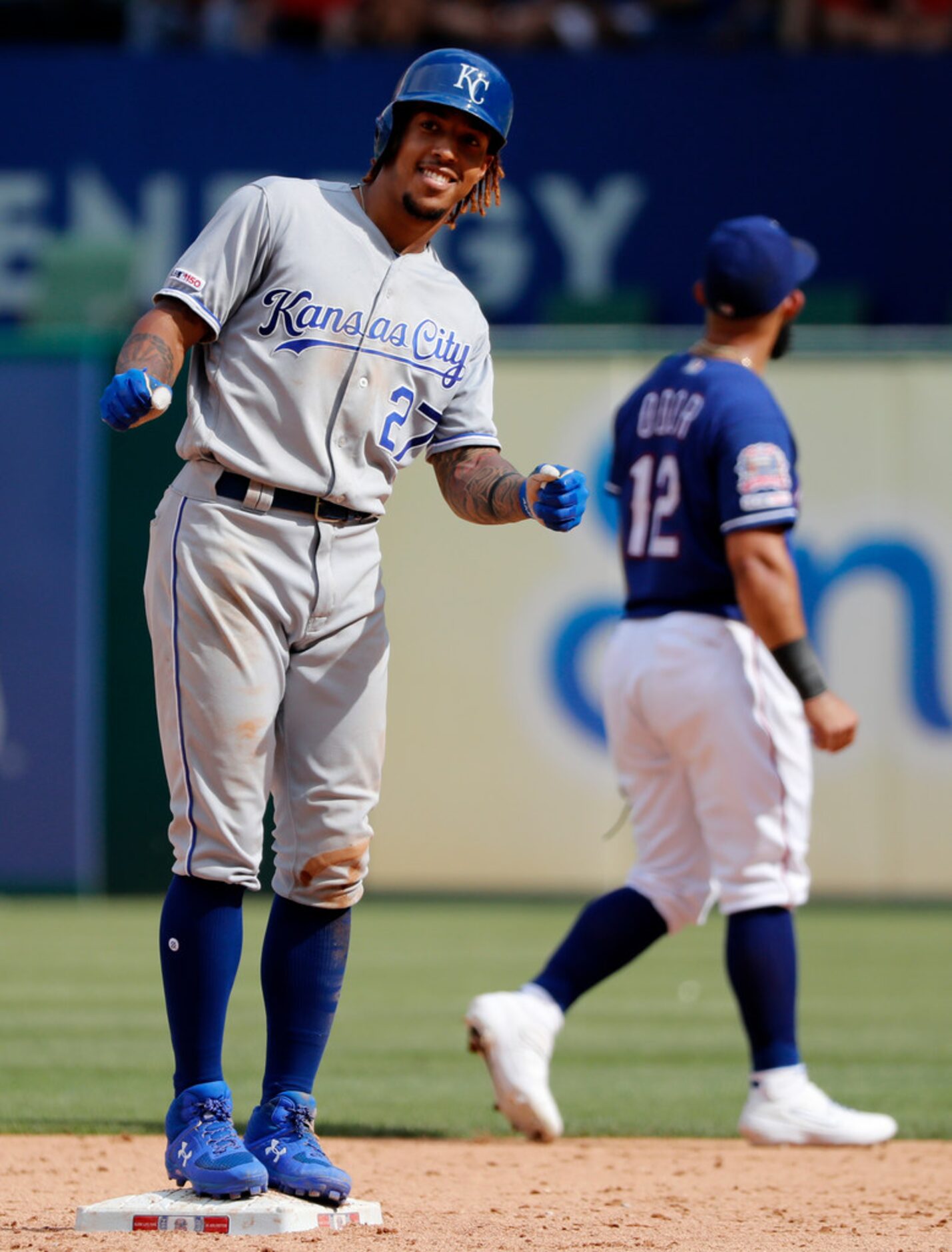 Kansas City Royals' Adalberto Mondesi, left, gestures to the dugout as he stands on the bag...