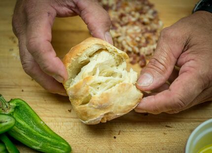 Mike Newton, known as the Cowboy Chef, shows off the flaky inside of one of his Angel...