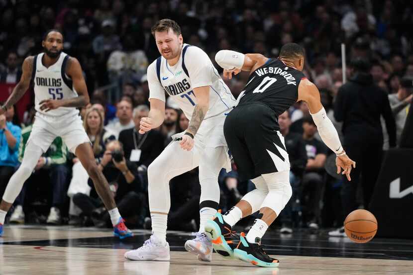 Los Angeles Clippers' Russell Westbrook (0) drives past Dallas Mavericks' Luka Doncic (77)...