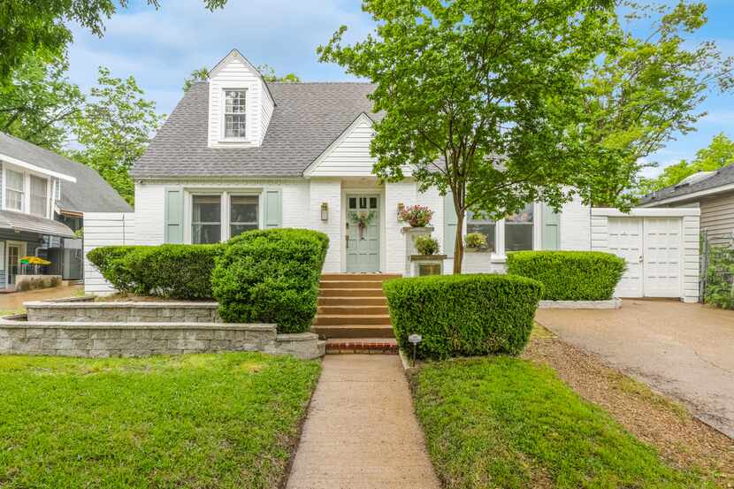 The updated 1930s home features a white brick exterior. Inside, there are four bedrooms and...