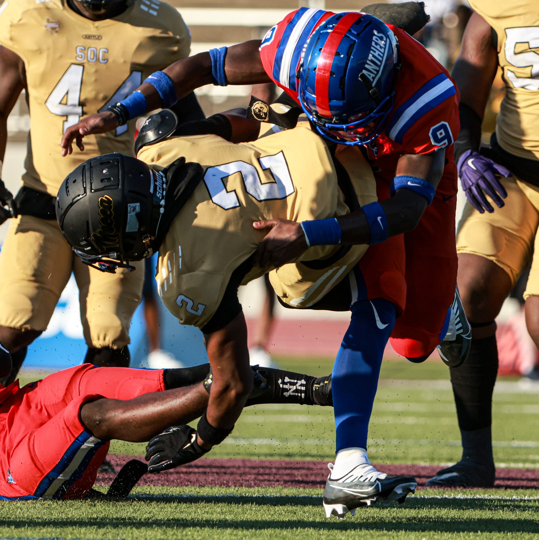 South Oak Cliff High School Kyron Chambers (2) gets tackled by Duncanville High School...