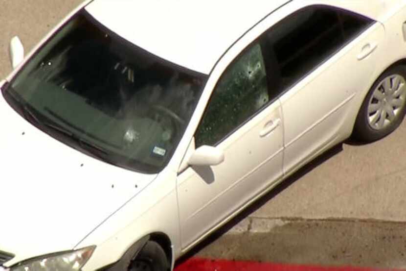Footage captured by the KXAS-TV (NBC5) helicopter showed a white sedan with several bullet...