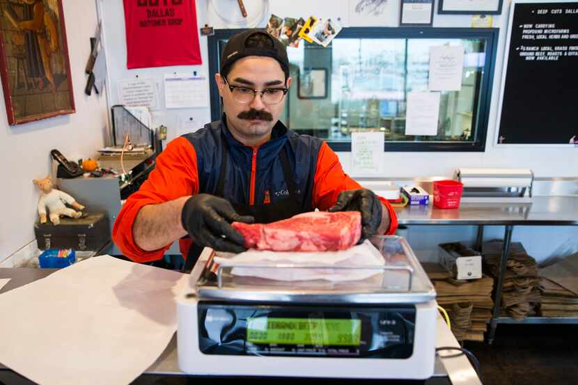 Nathan Abeyta, co-owner of butcher shop Deep Cuts Dallas, prepares a to-go order for a...