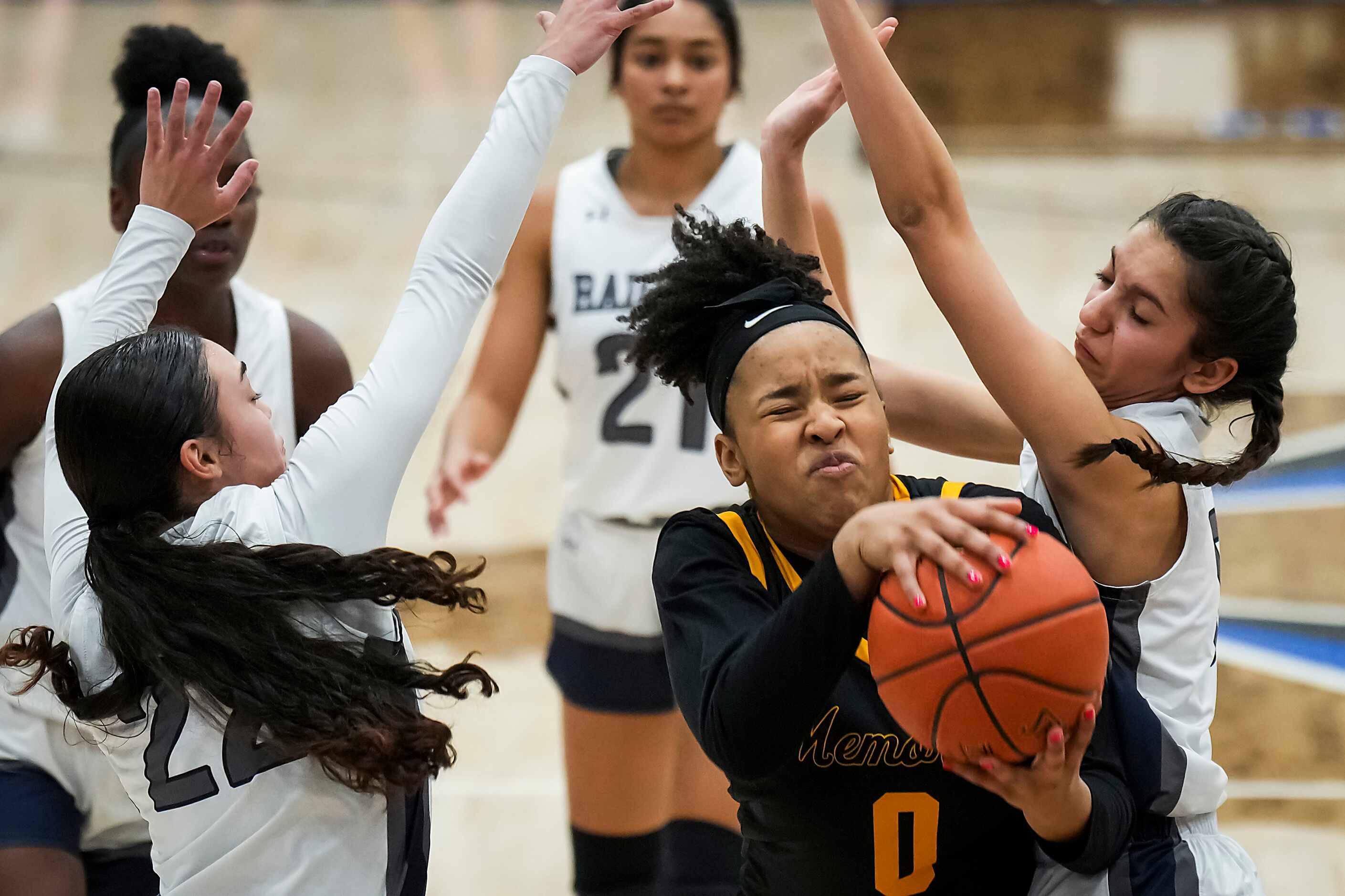 Frisco Memorial's Brynn Lusby (0)drives between Wylie East's Aaliyah Halstied (22) and...