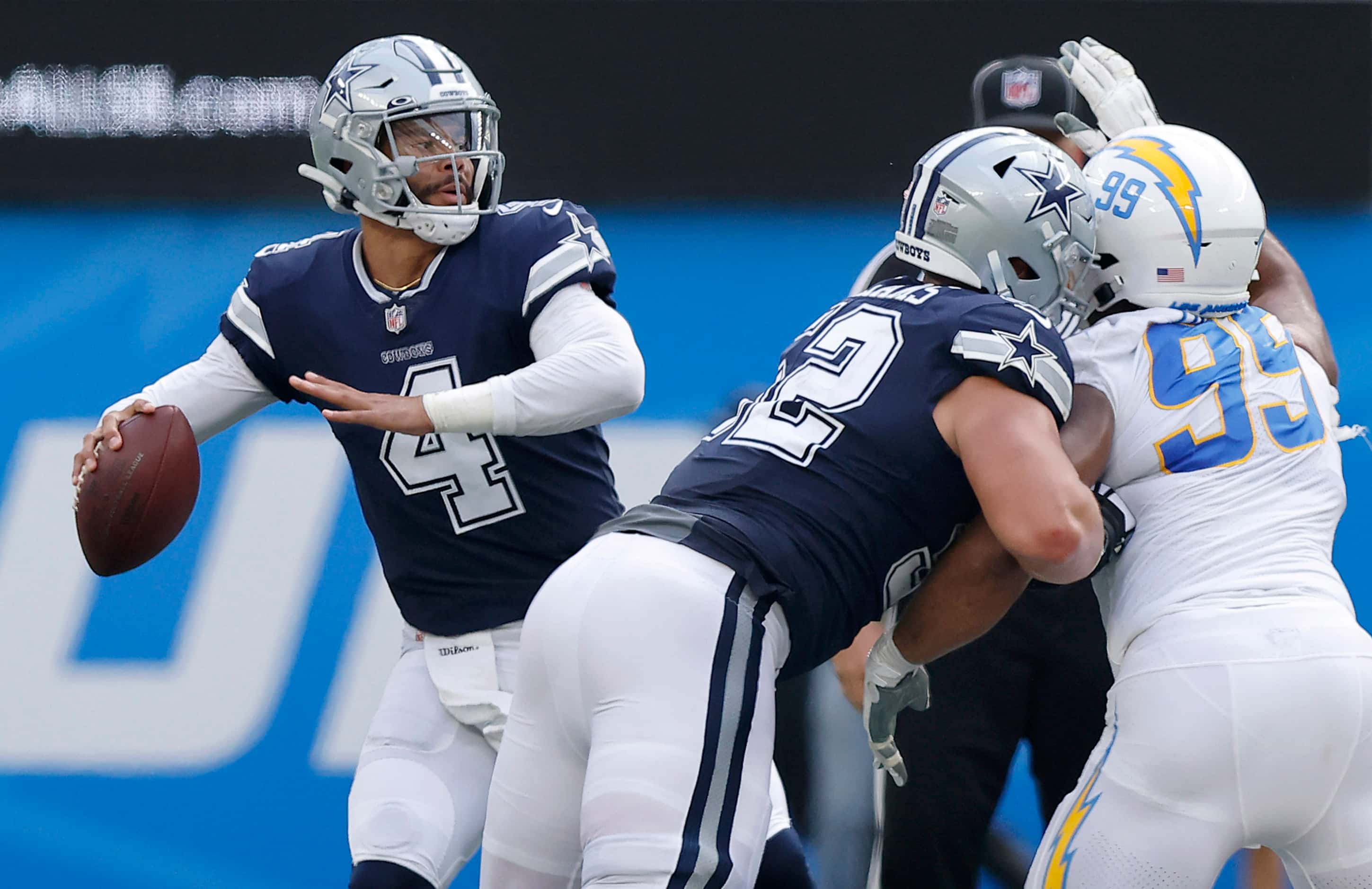 Dallas Cowboys quarterback Dak Prescott (4) looks to the sideline for a receiver as he gets...