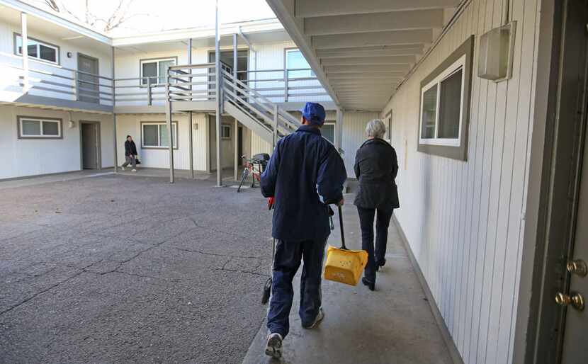 Willie Hodge works cleaning the grounds of the East Dallas apartment complex where he also...
