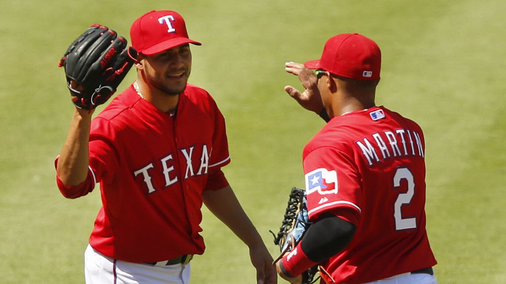 Texas Rangers starting pitcher Martin Perez (33) thanks center fielder Leonys Martin (2) on...