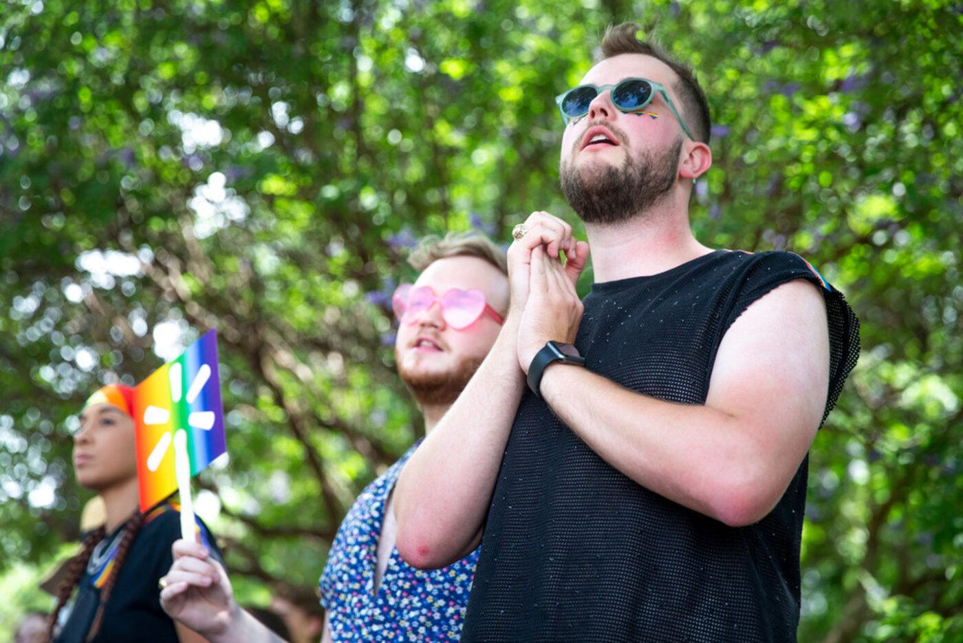 Alex Karshis, right, of Houston, watches the parade go by along with Sean Christopher,...