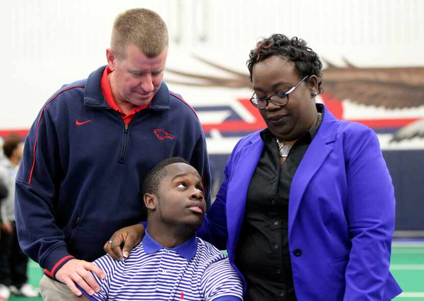 Kendall Clinton looks up at his mom Sharon Clinton while posing for photos with Allen head...