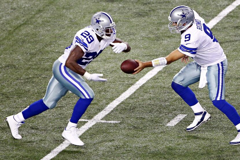 Dallas Cowboys quarterback Tony Romo (9) hands off to running back DeMarco Murray during the...