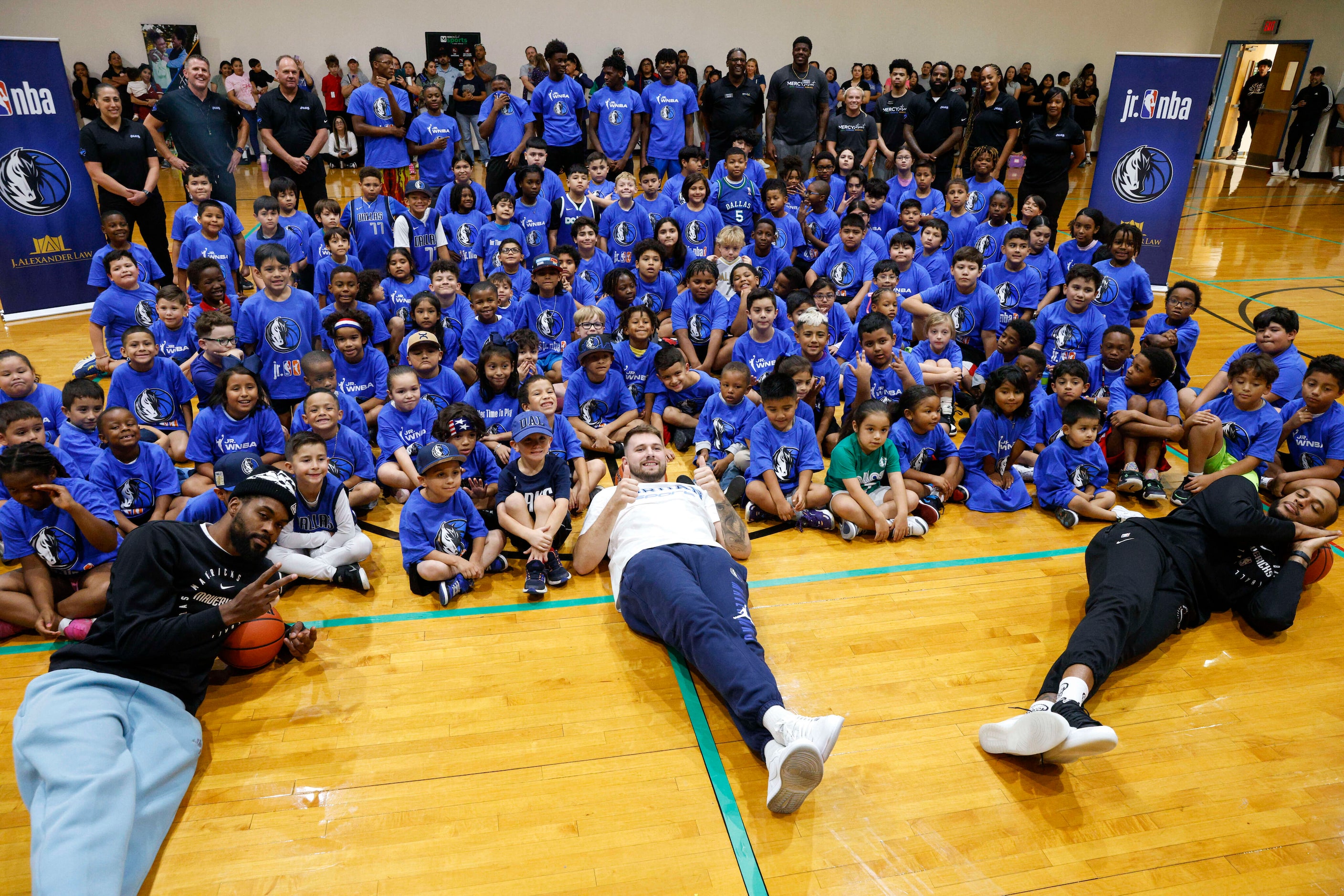 Dallas Mavericks players Naji Marshall (left), Luka Doncic (center) and Daniel Gafford pose...