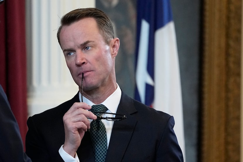 FILE - Texas Speaker of the House Dade Phelan, right, talks with a fellow lawmaker in the...