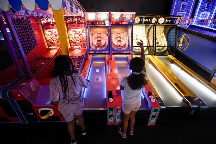 Kori Williams (left), 7, and Victoria Jusino, 9, launch balls at the backboard of an Ice...