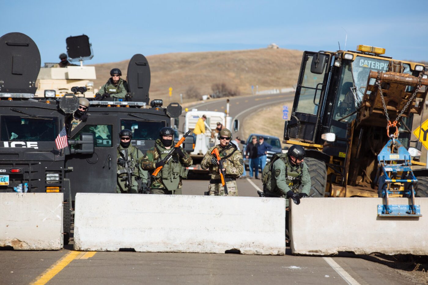 Police face off Saturday against protesters occupying a bridge immediately north of the...