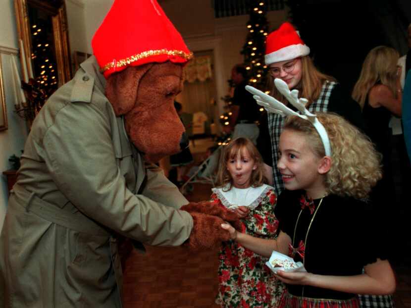 McGruff the Crime Dog, left, greets Scarlett Deering, then 9, right, while her sisters...