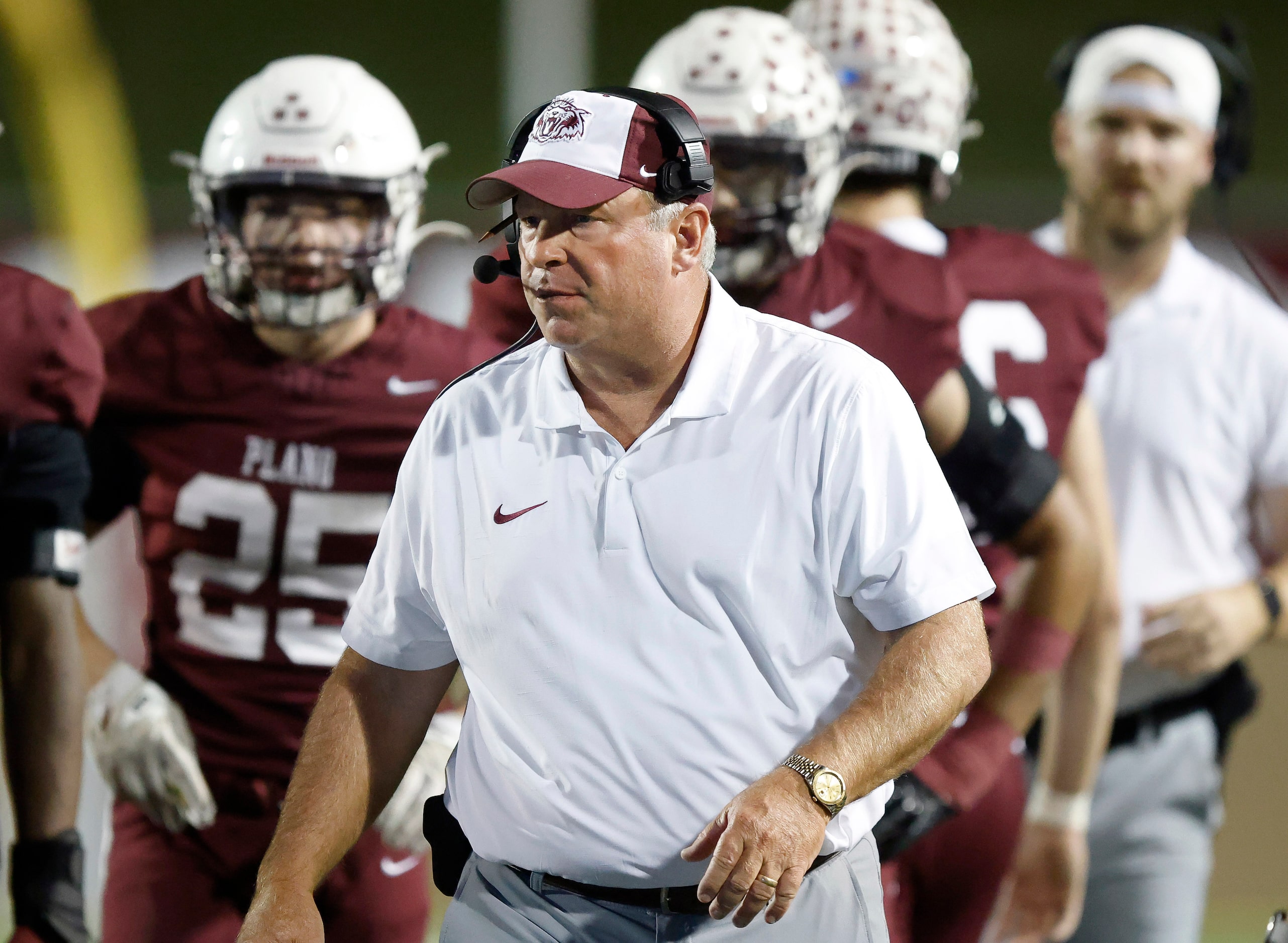 Plano High head coach Cody White walks the sideline during their football game against...