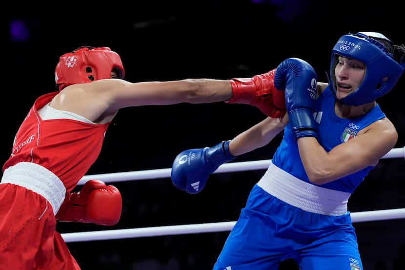 Algeria's Imane Khelif, left, fights Italy's Angela Carini in their women's 66kg preliminary...