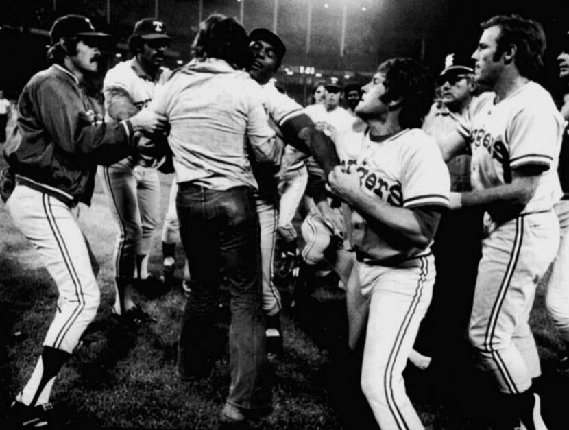 Rangers players, armed with bats, stormed the field to defend outfielder Jeff Burroughs and...