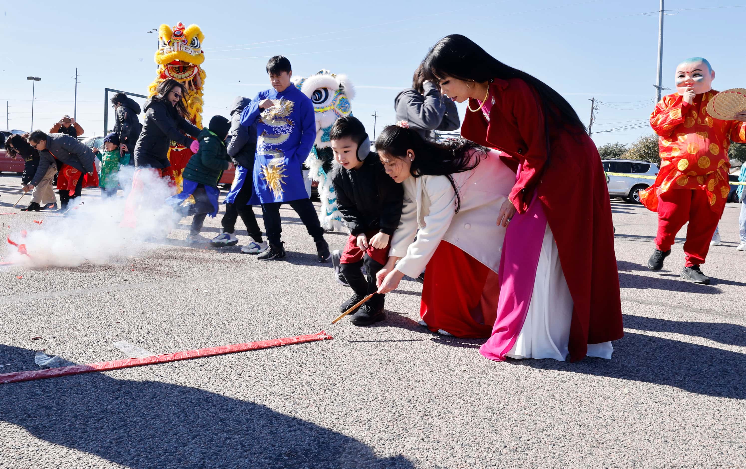 Attendees light firecrackers during a Lunar New Year celebration at the parking lot of Cali...