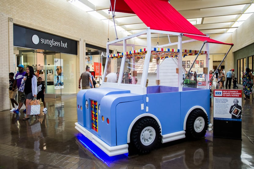A playhouse in the shape of a vehicle is on display as part of the Parade of Playhouses,...