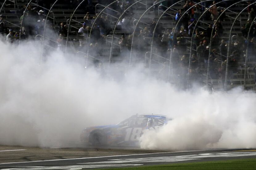 Kyle Busch celebrates with a burnout during O'Reilly Auto Parts 300 at Texas Motor Speedway...