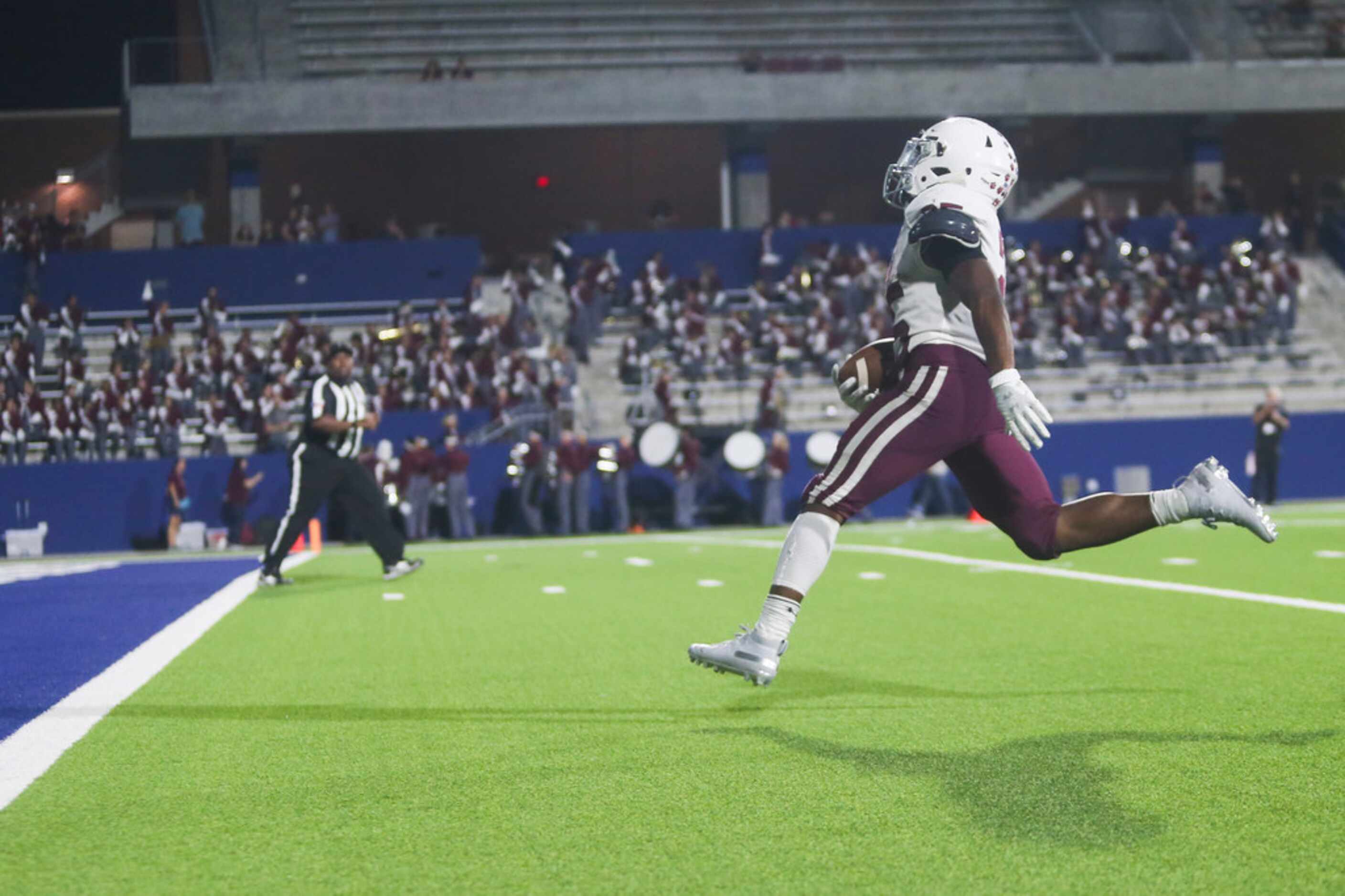 Plano running back Tylan Hines (25) scores a touchdown during the second half of a high...