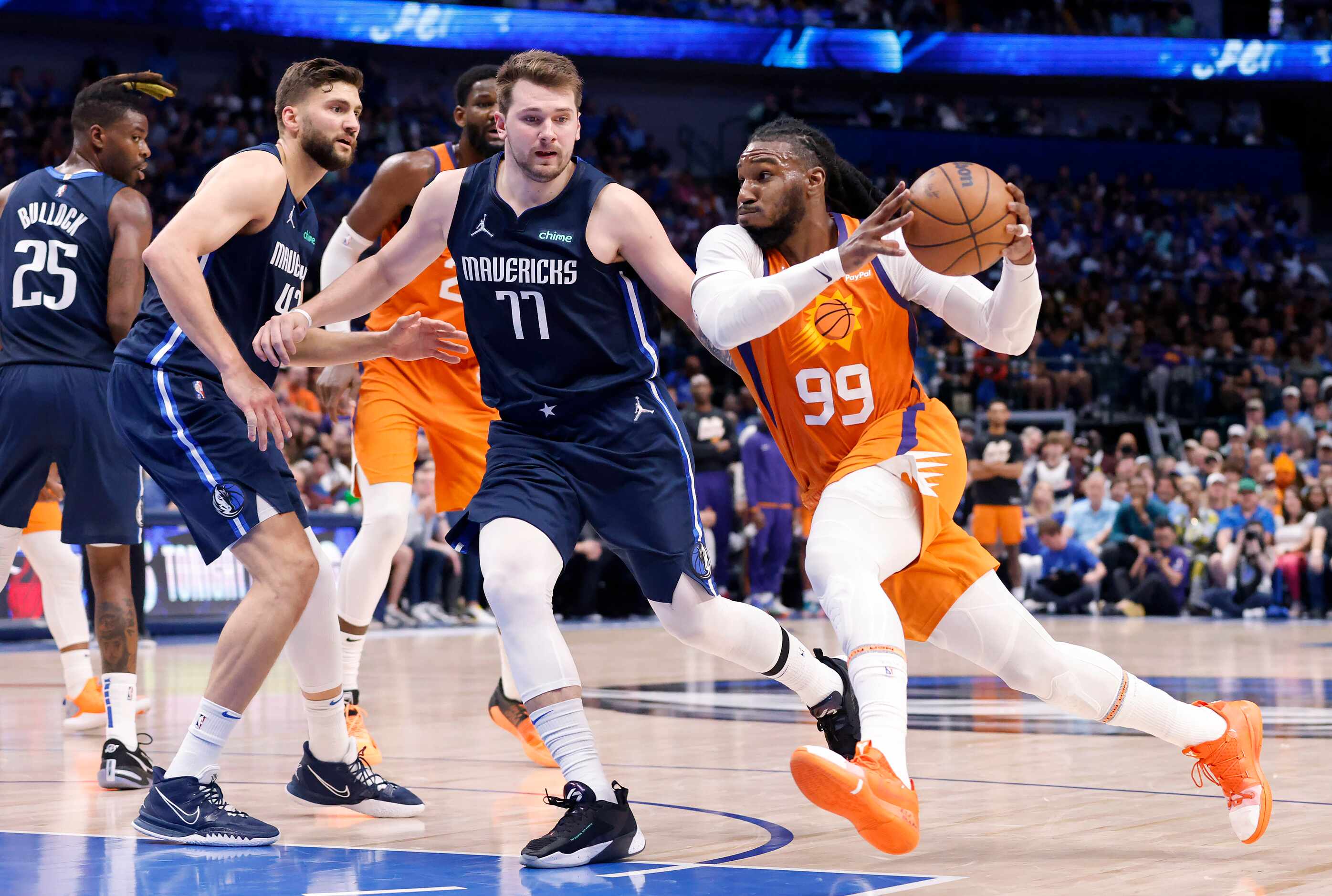 Phoenix Suns forward Jae Crowder (99) drives to the lane as he’s guarded by Dallas Mavericks...