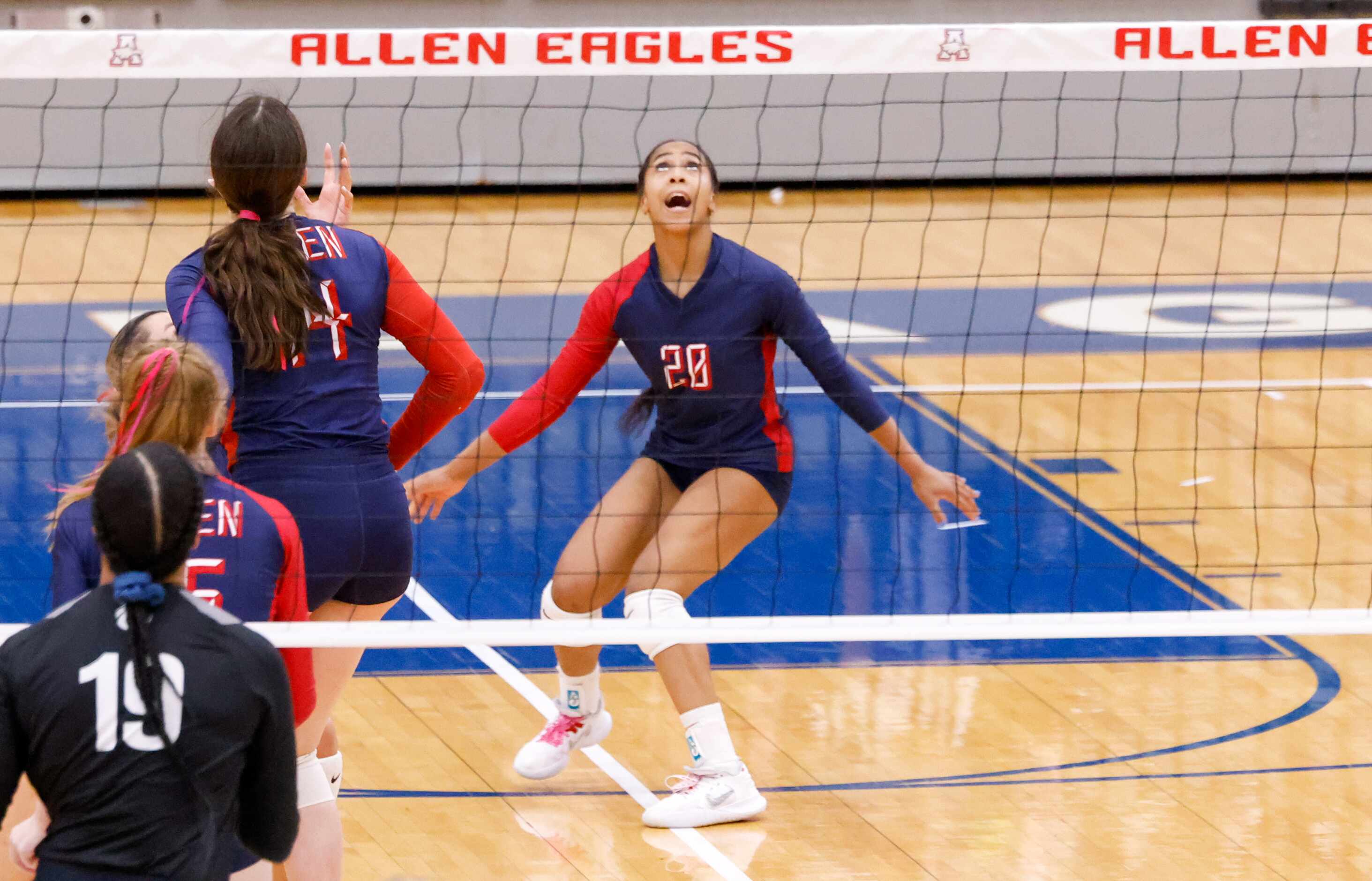 Allen freshman Kennedy Crayton (20) yells as she watches for the ball to come down on...