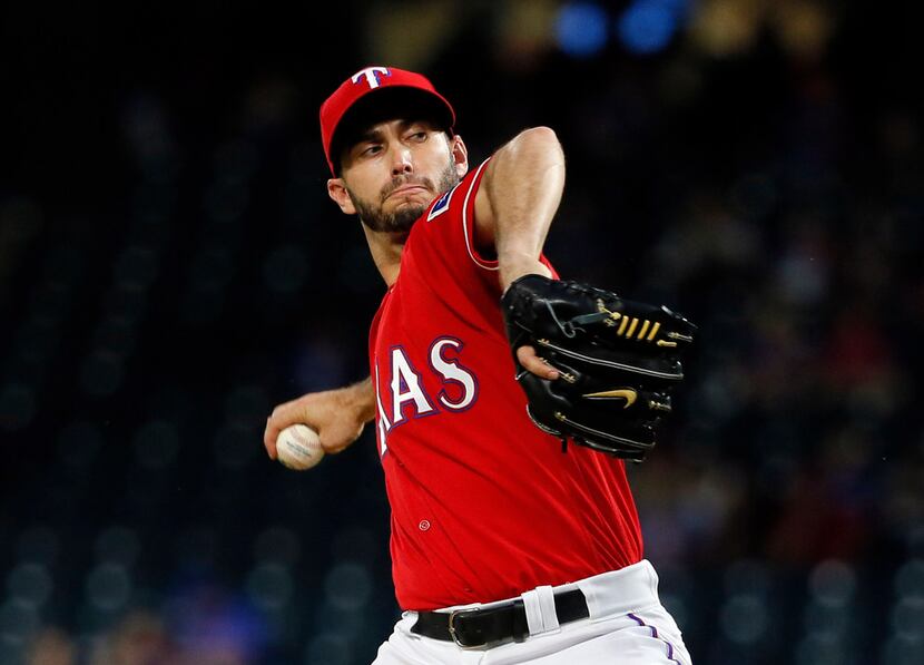 Texas Rangers starting pitcher Miguel Gonzalez throws to the Oakland Athletics in the first...