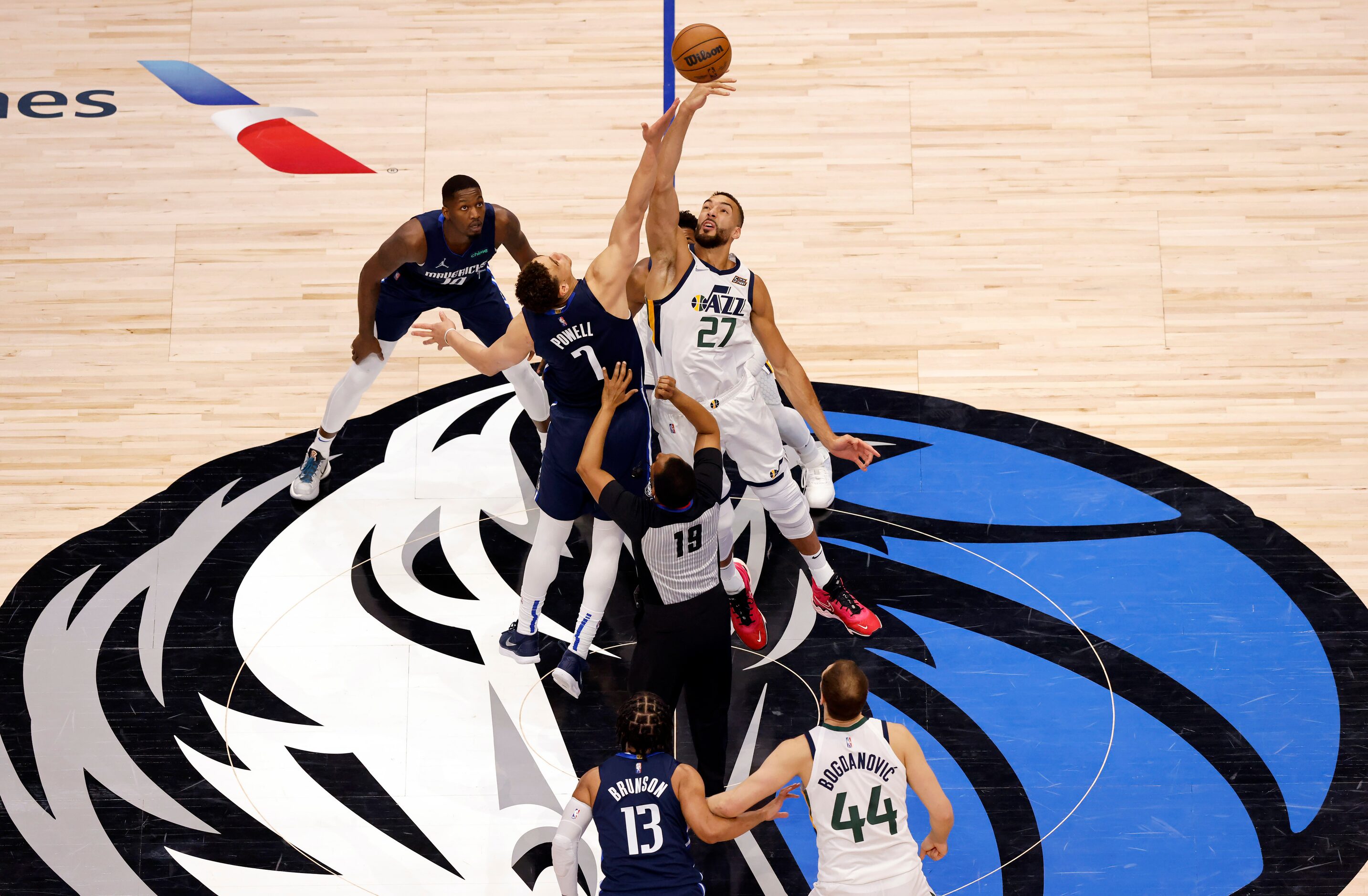 Dallas Mavericks center Dwight Powell (7) and Utah Jazz center Rudy Gobert (27) jump for the...