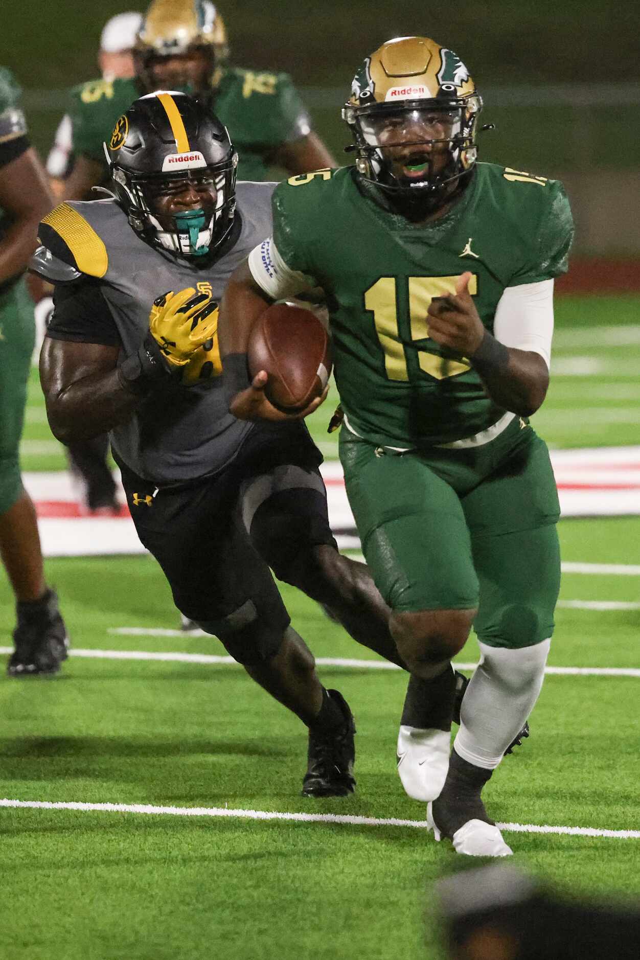 DeSoto High School Darius Bailey (15) runs the ball up the field while trailed by St....