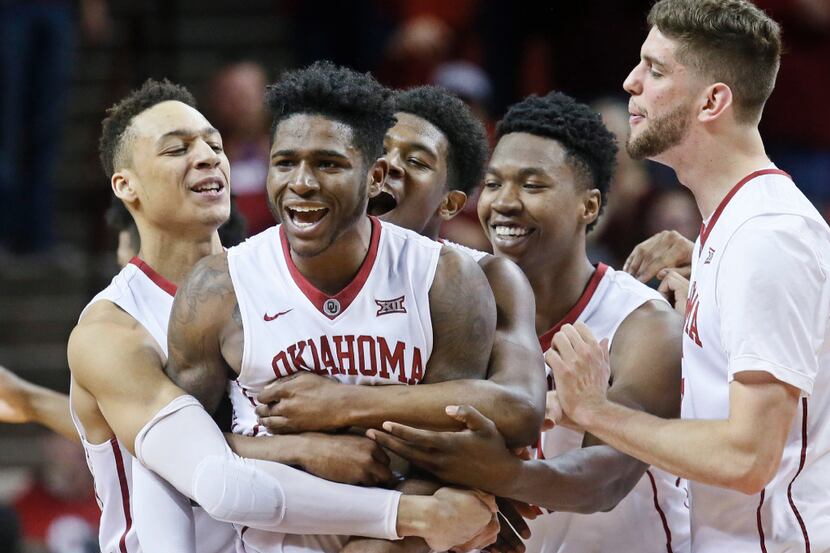 Oklahoma players, from left, Jamuni McNeace, Rashard Odomes, Kameron McGusty, Kristian...