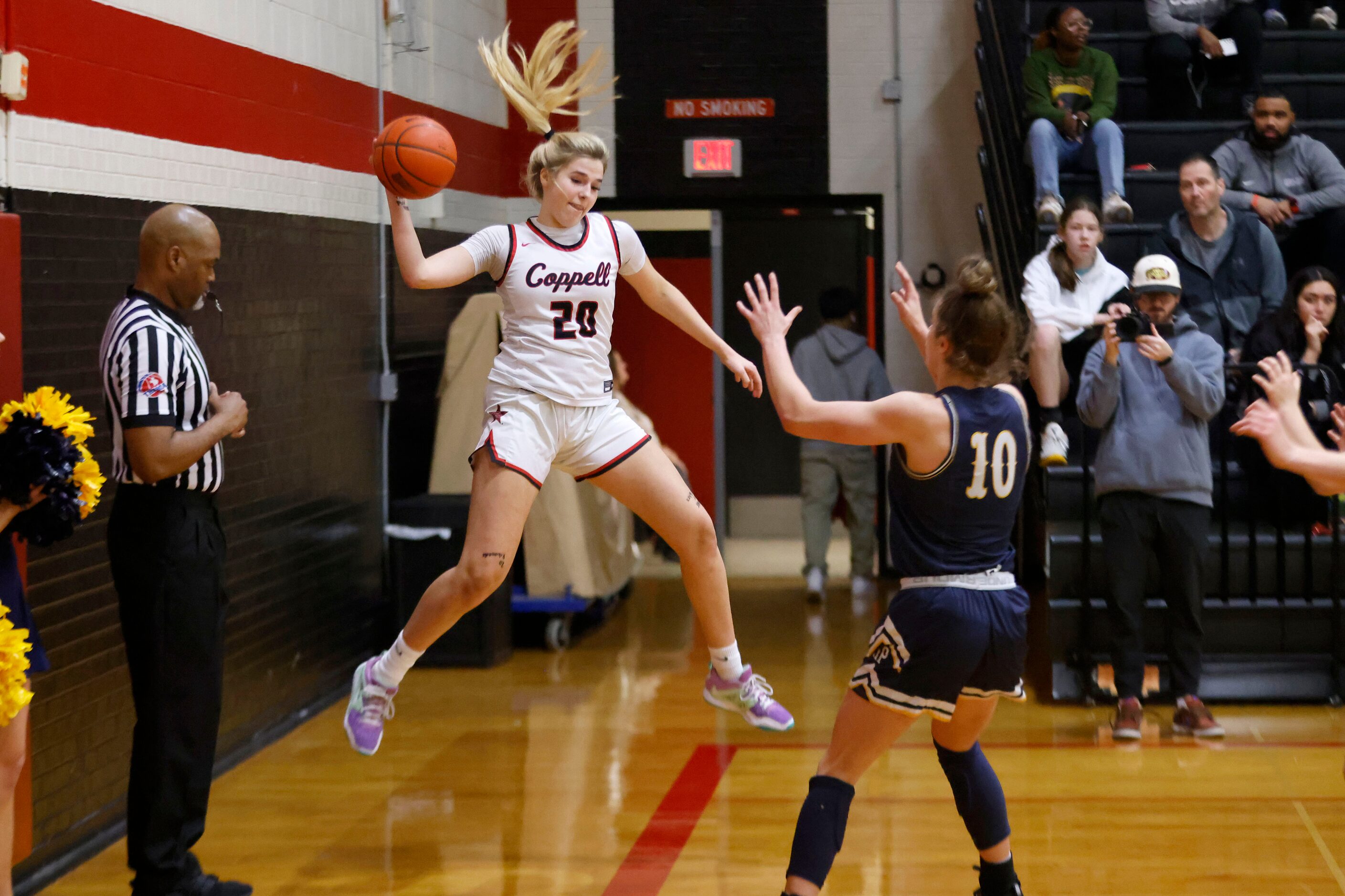 Coppell’s Jules LaMendola (20) saves the ball off of Highland Park’s Paris Lauro (10) during...