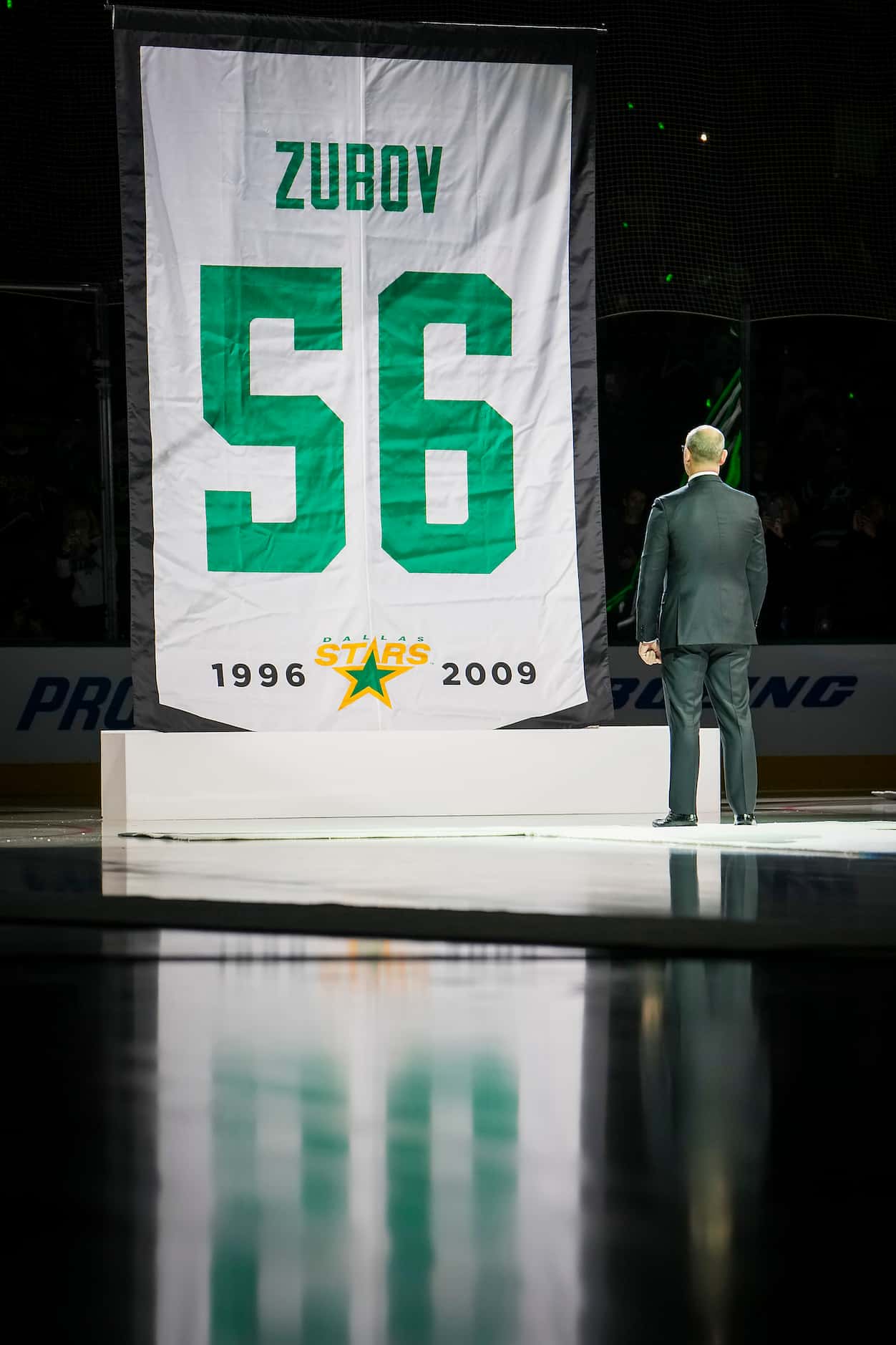 Former Dallas Stars player Sergei Zubov watches as a banner bearing his number 56 is raised...