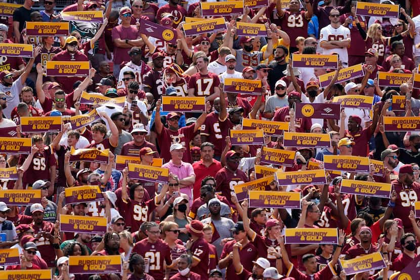 Fans of the Washington Football Team cheering from the stands at FedEx Field during the...
