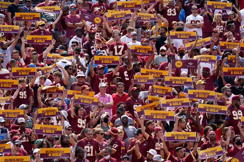 Fans of the Washington Football Team cheering from the stands at FedEx Field during the...