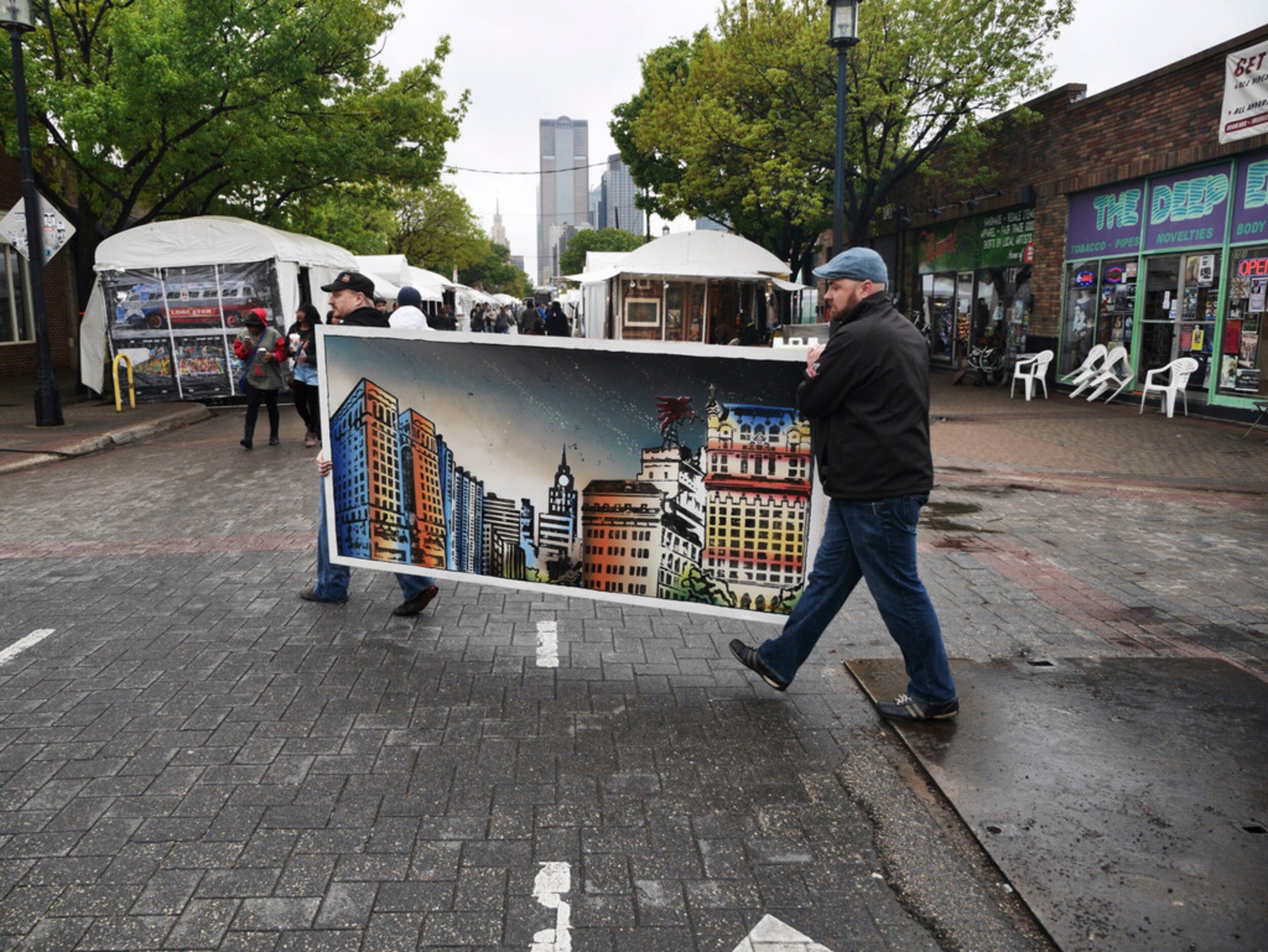 Brad Albright (left) and Justin Clumpner take advantage of a break in the rain to move a...