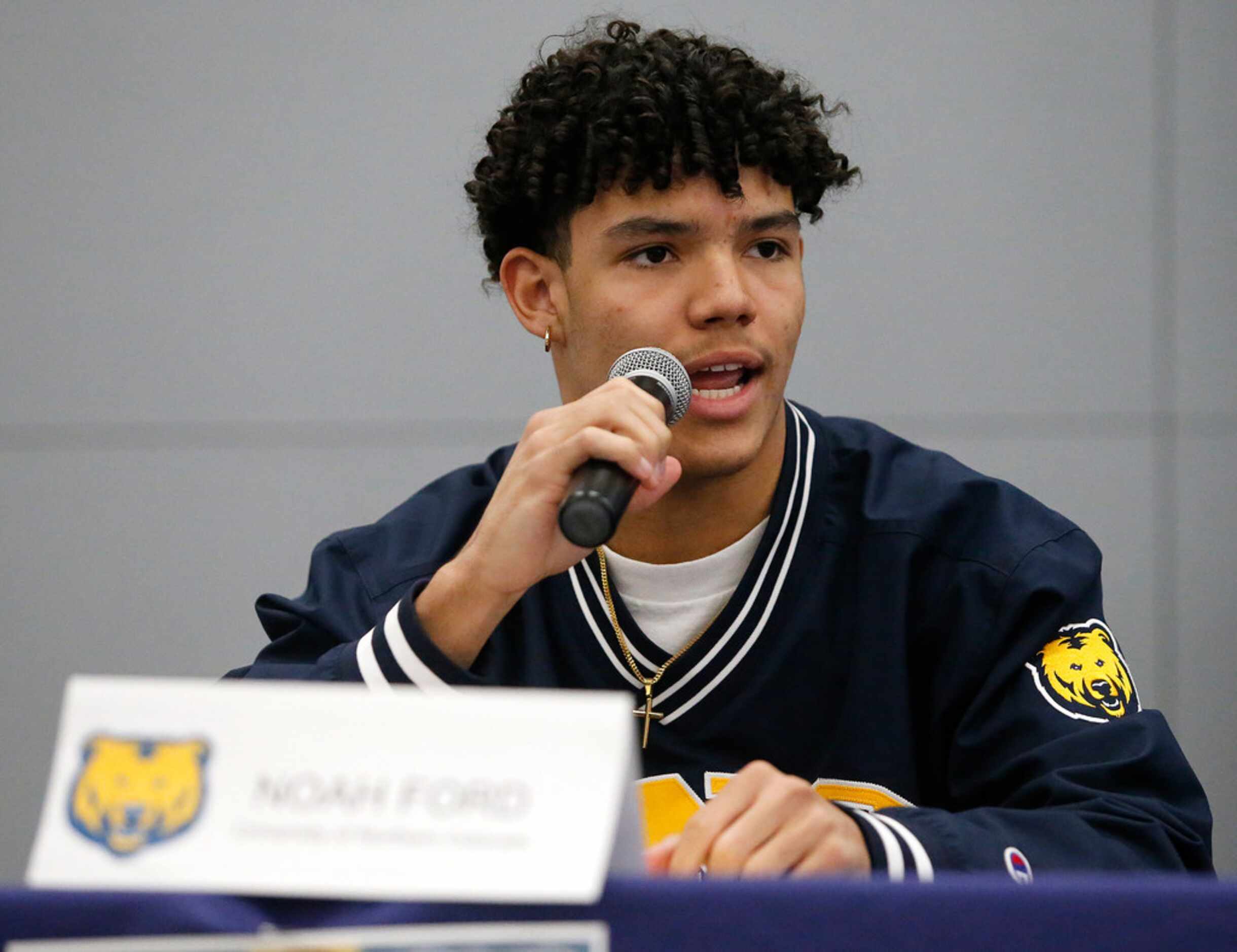 Noah Ford uses a microphone to speak before signing with Northern Colorado during the...