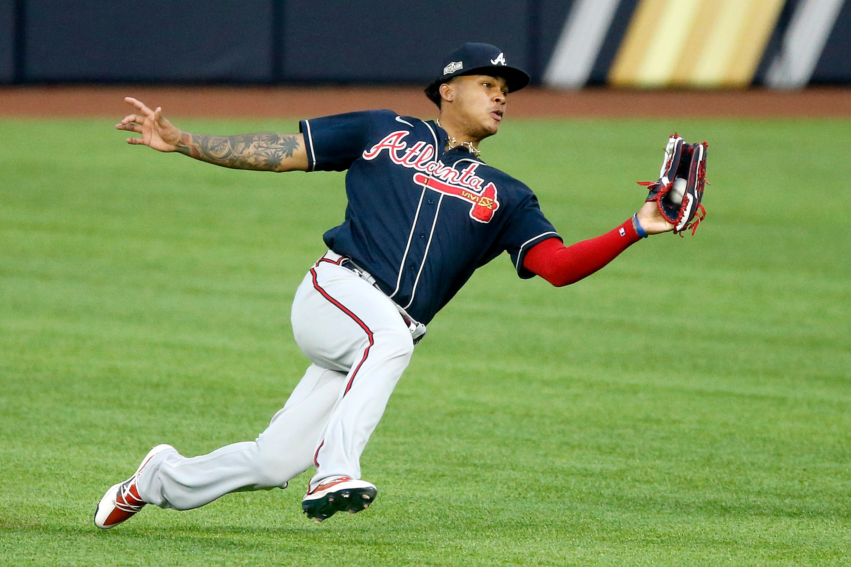 Atlanta Braves center fielder Cristian Pache (14) makes a sliding catch on a ball hit by Los...