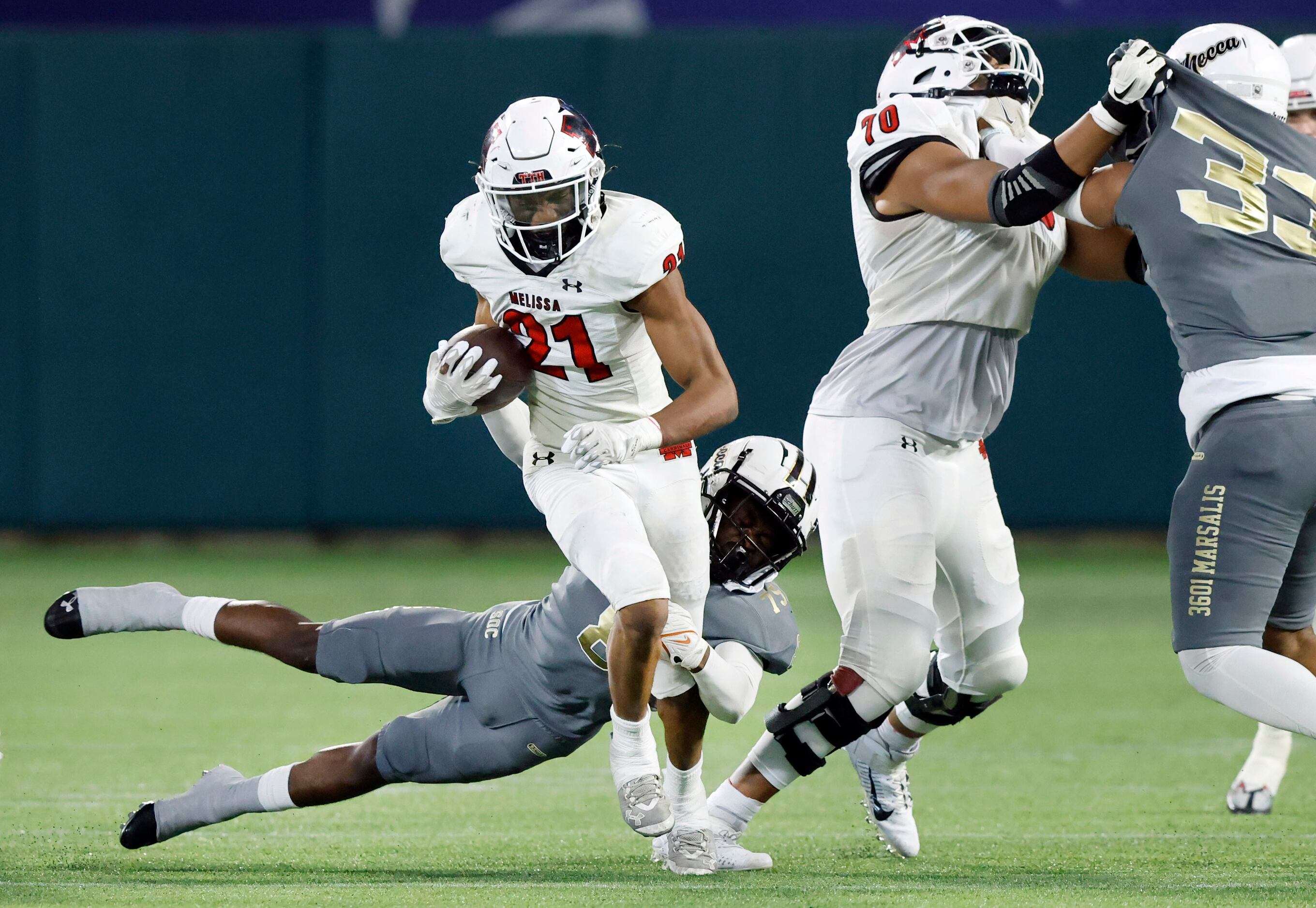 South Oak Cliff linebacker Brandon Jones (8) makes a diving tackle of Melissa running back...