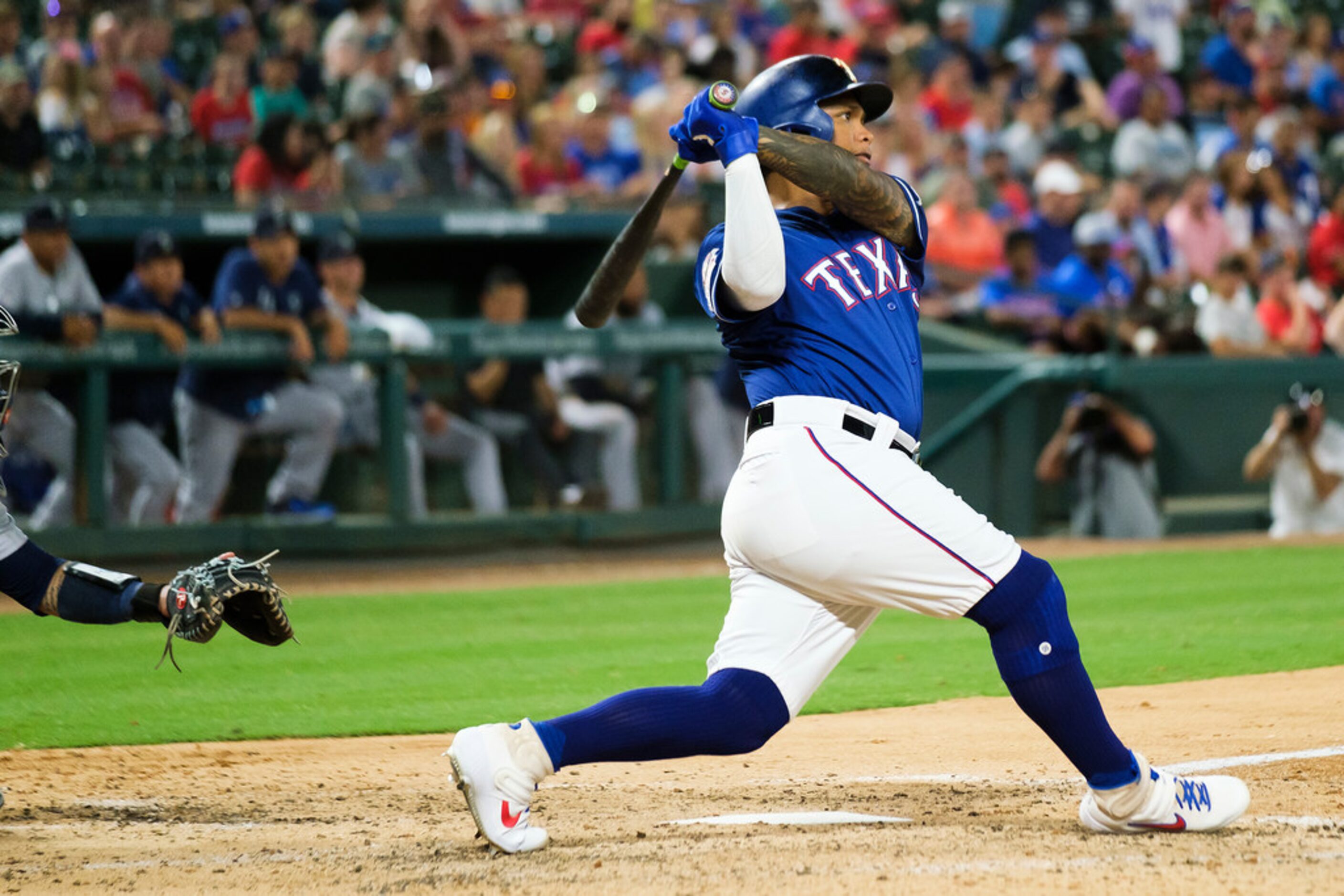 Texas Rangers left fielder Willie Calhoun hits a 3-run home run during the fifth inning...