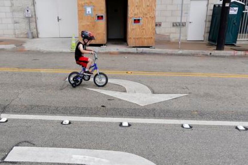
Gavin Hildebrand, 4, pedaled along Harwood Street during the Uptown Ciclovía, which...
