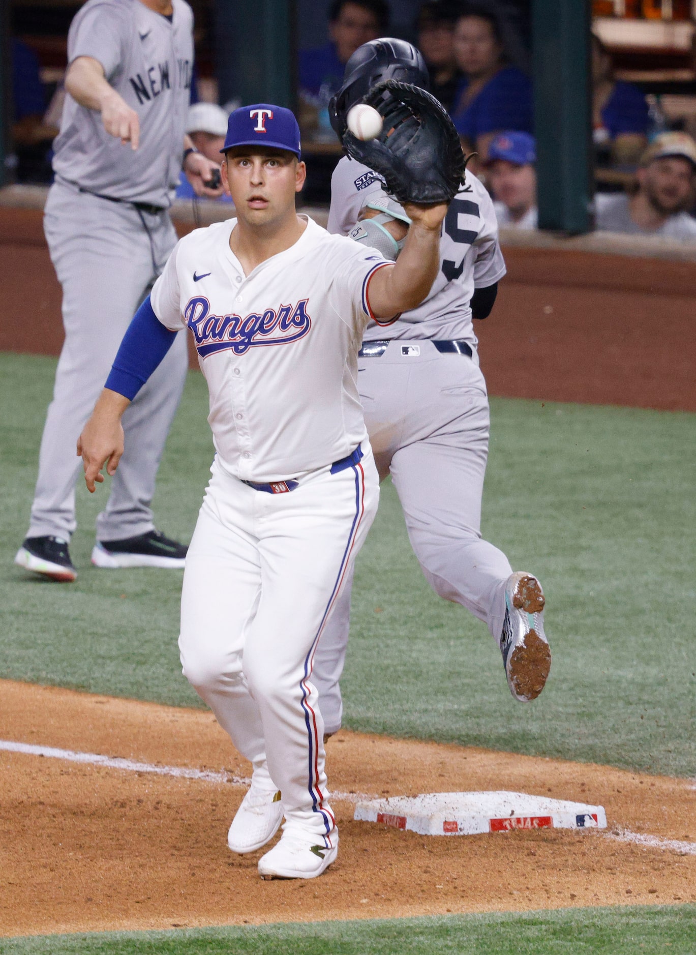 Texas Rangers first base Nathaniel Lowe (30) receives a ball after New York Yankees Gleyber...