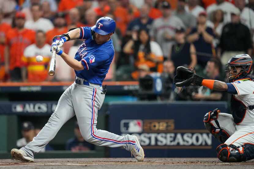 Texas Rangers shortstop Corey Seager (5) hits a solo home run against Houston Astros...